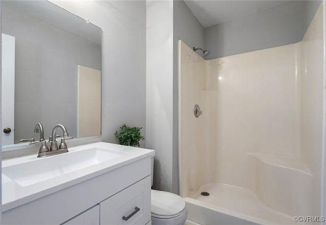 full bath featuring a shower, vanity, and toilet