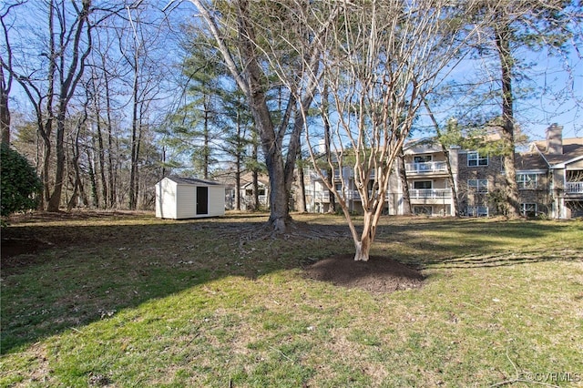 view of yard featuring an outbuilding and a shed