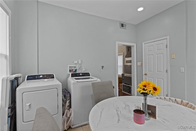 clothes washing area featuring visible vents, laundry area, light tile patterned flooring, recessed lighting, and washing machine and dryer