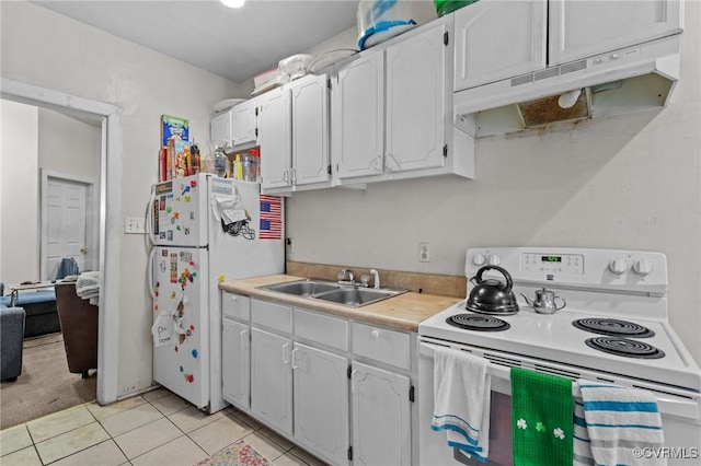 kitchen with under cabinet range hood, a sink, white cabinetry, white appliances, and light tile patterned floors