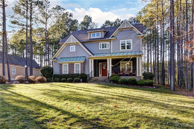 craftsman house with a porch, a front yard, a standing seam roof, and metal roof