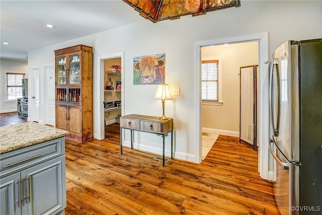 kitchen with dark wood-style floors, gray cabinets, freestanding refrigerator, and recessed lighting