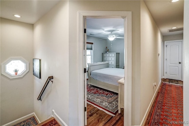 hallway featuring recessed lighting, wood finished floors, an upstairs landing, and baseboards