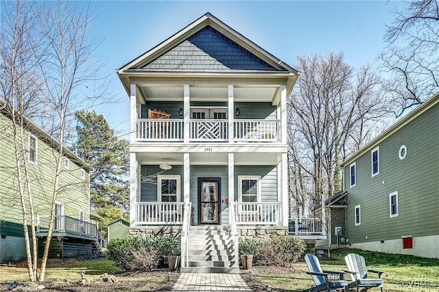 view of front of property with covered porch and a balcony