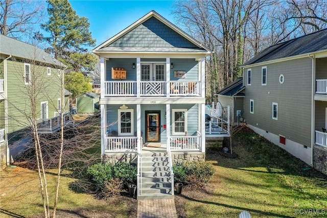 view of front of home featuring a porch, stairway, and a balcony