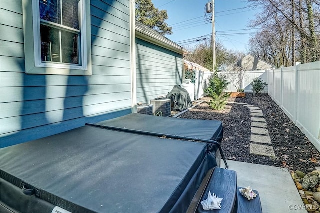 exterior space featuring a fenced backyard and central air condition unit