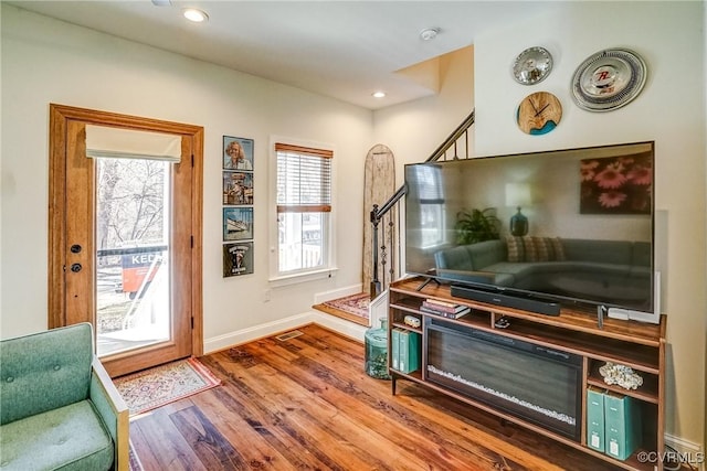 entryway featuring baseboards, stairway, wood finished floors, and recessed lighting