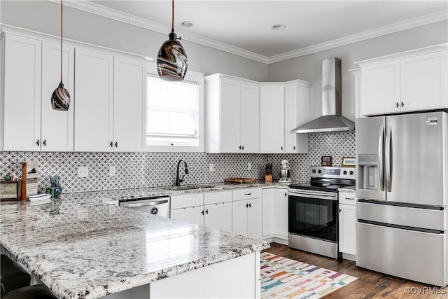 kitchen with a peninsula, wall chimney exhaust hood, white cabinets, and stainless steel appliances