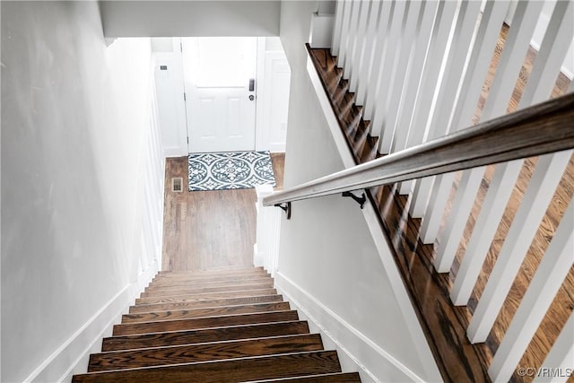 stairs with visible vents and wood finished floors