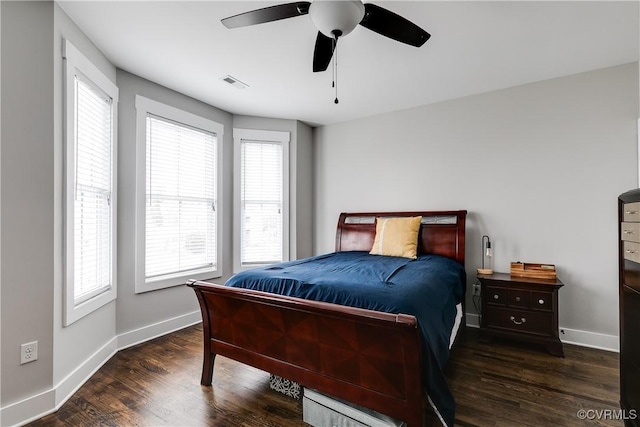 bedroom featuring visible vents, baseboards, and wood finished floors