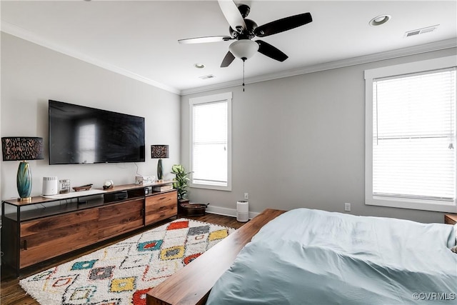 bedroom with baseboards, dark wood-style flooring, visible vents, and crown molding