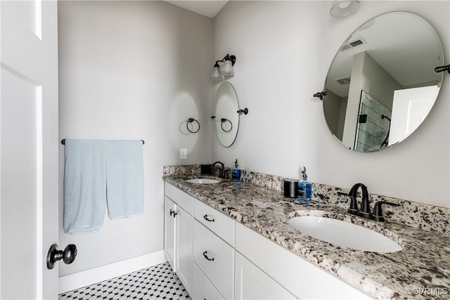 bathroom with visible vents, a sink, and double vanity