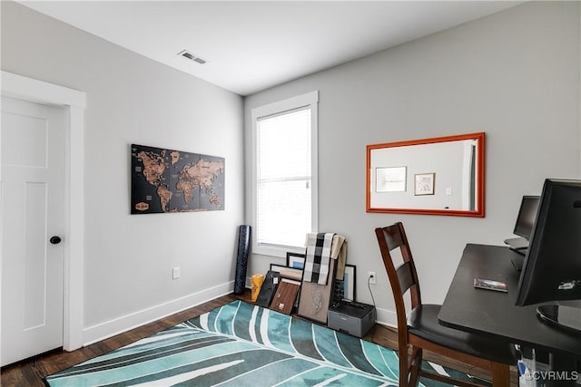 office with baseboards, visible vents, and wood finished floors