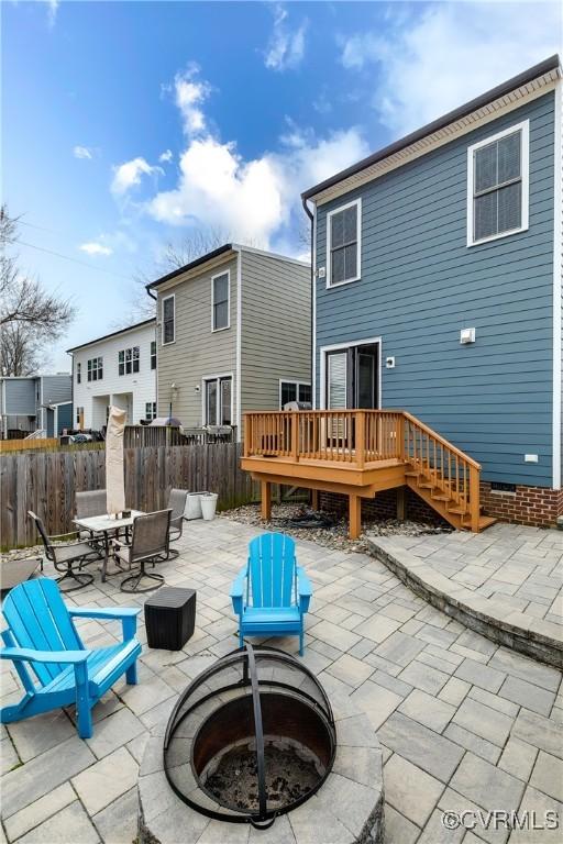 back of house featuring a deck, a patio, a fire pit, fence, and crawl space