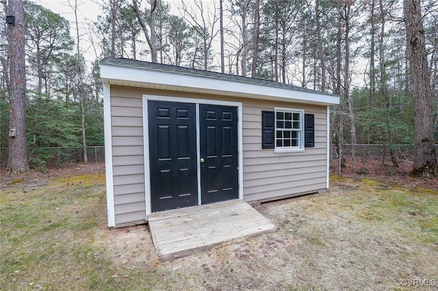 view of outbuilding featuring an outbuilding and fence