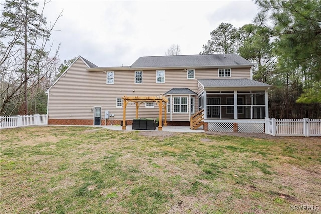 rear view of house featuring a sunroom, a fenced backyard, and a yard