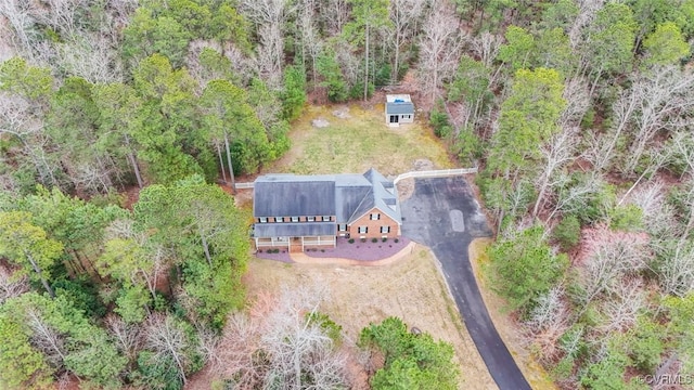 birds eye view of property with a view of trees