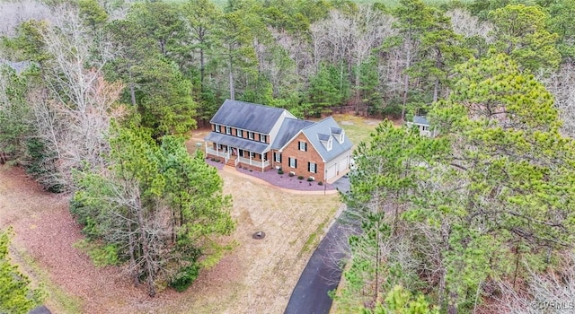 drone / aerial view featuring a view of trees