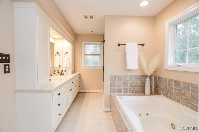 full bath featuring double vanity, baseboards, tile patterned floors, a jetted tub, and a sink