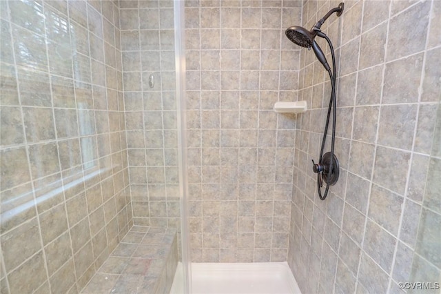 full bath with a tile shower