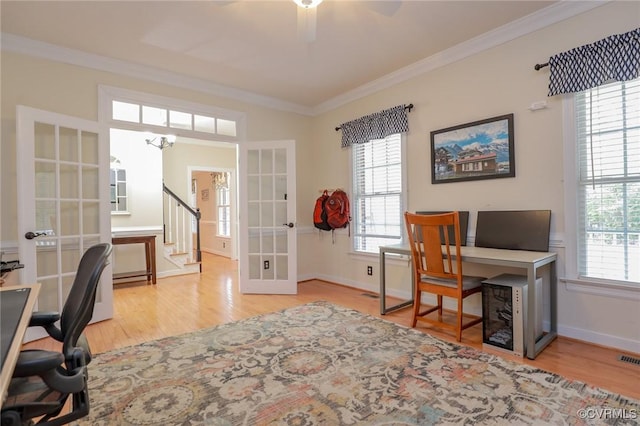 office with baseboards, wood finished floors, crown molding, and french doors