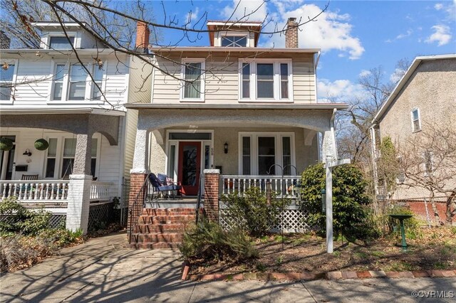 traditional style home with covered porch and a chimney