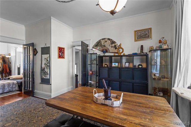 dining room with baseboards, wood finished floors, and ornamental molding