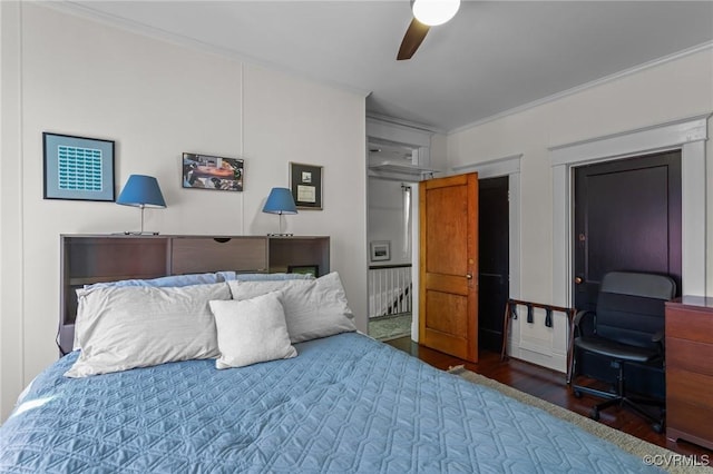 bedroom featuring crown molding, a ceiling fan, and wood finished floors