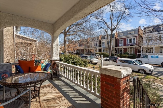 balcony with covered porch and a residential view