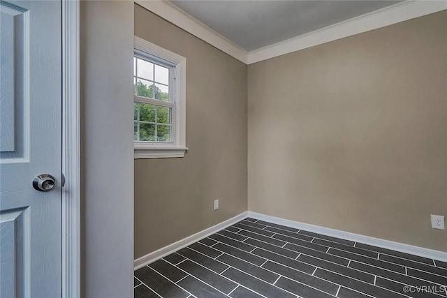 unfurnished room with crown molding and baseboards