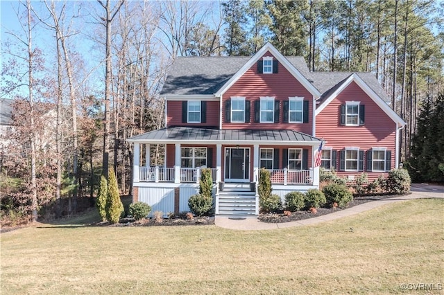 view of front of property with a porch, a front yard, a standing seam roof, metal roof, and stairs