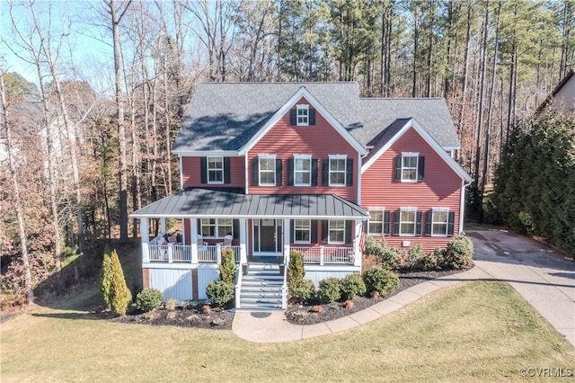 view of front of home with covered porch, driveway, stairway, and a front yard