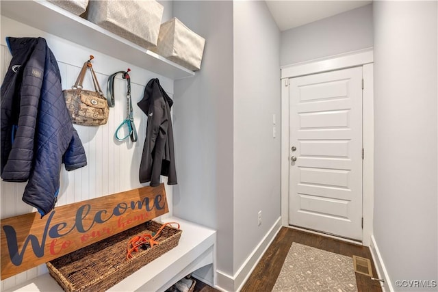 mudroom with wood finished floors, visible vents, and baseboards