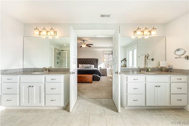 ensuite bathroom with ensuite bath, a stall shower, a sink, and visible vents