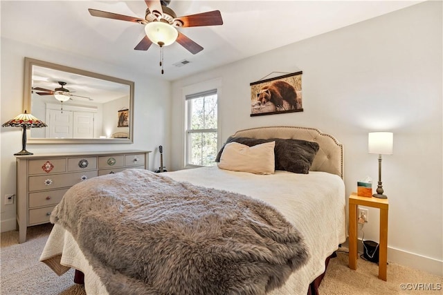 bedroom with light colored carpet, visible vents, ceiling fan, and baseboards