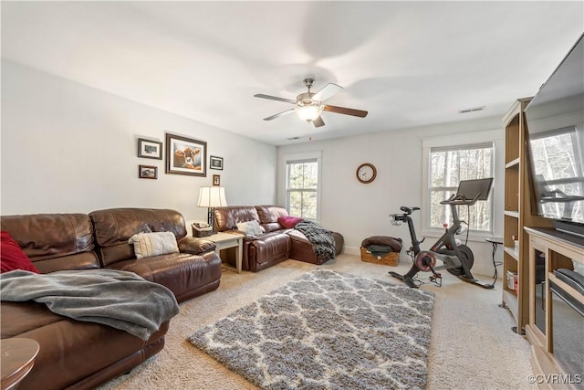 carpeted living room featuring ceiling fan and visible vents