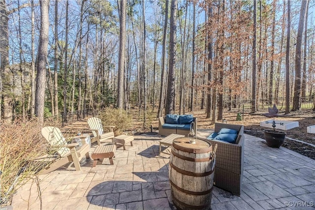 view of patio featuring an outdoor living space with a fire pit and fence