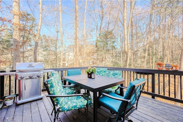 wooden deck featuring outdoor dining space and area for grilling