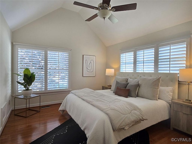 bedroom with lofted ceiling, ceiling fan, multiple windows, and wood finished floors