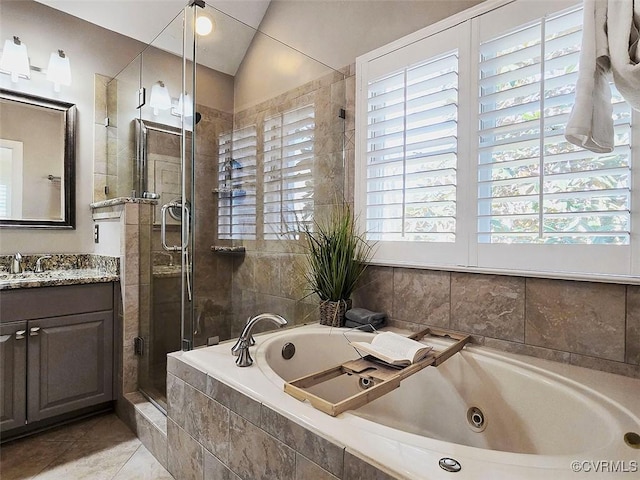 full bath featuring tile patterned flooring, vanity, vaulted ceiling, a jetted tub, and a shower stall