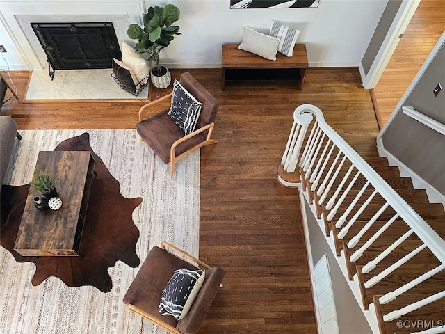 living room with stairs, baseboards, and wood finished floors