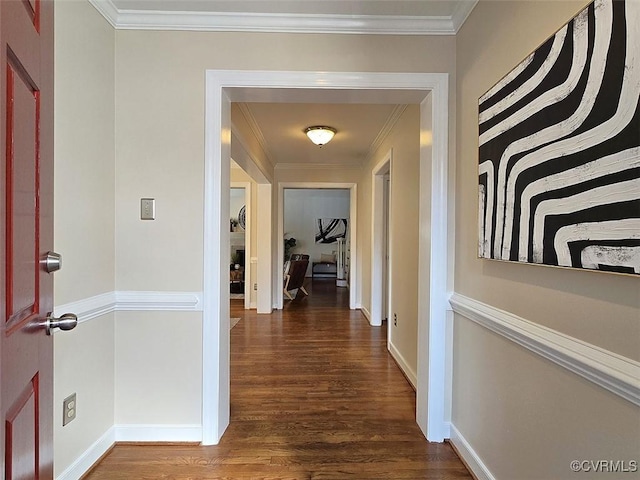 hall featuring dark wood-style floors, ornamental molding, and baseboards