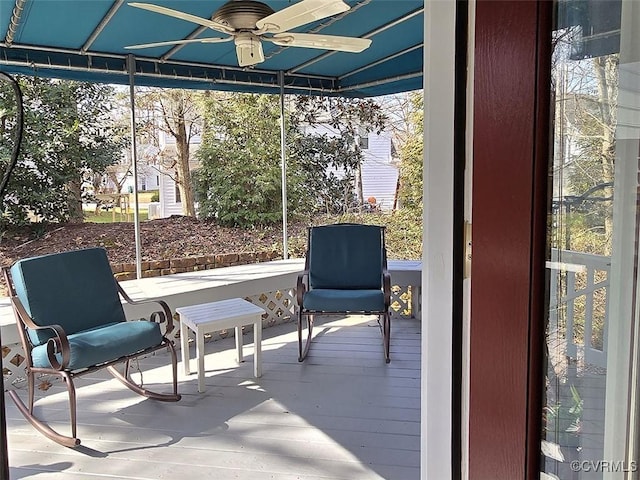 sunroom / solarium featuring plenty of natural light and a ceiling fan