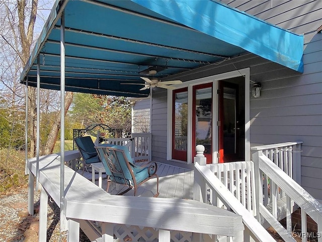 wooden terrace with ceiling fan and outdoor dining area