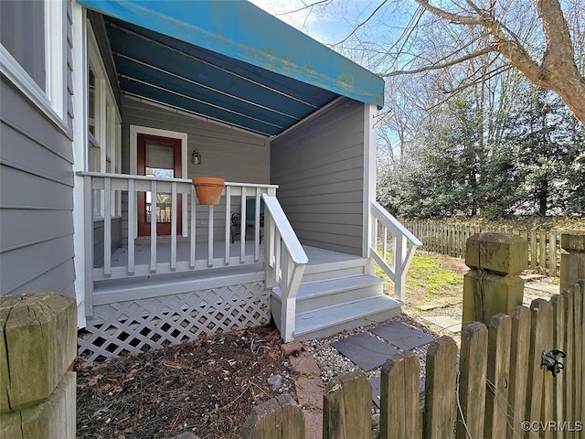 exterior space with covered porch and fence