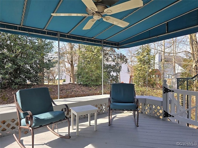 sunroom / solarium featuring plenty of natural light and a ceiling fan