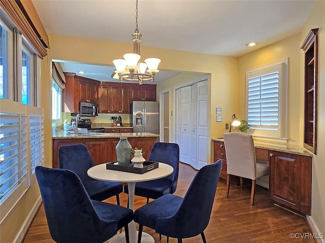 dining area featuring baseboards, dark wood-style flooring, recessed lighting, and a notable chandelier