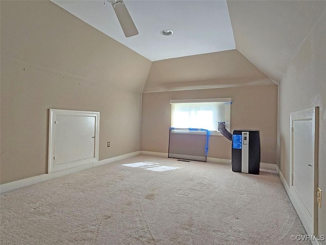 additional living space featuring vaulted ceiling, ceiling fan, light carpet, and baseboards