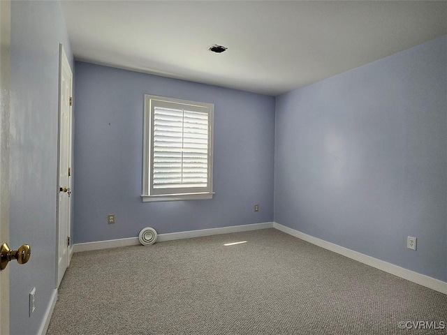 carpeted spare room with baseboards