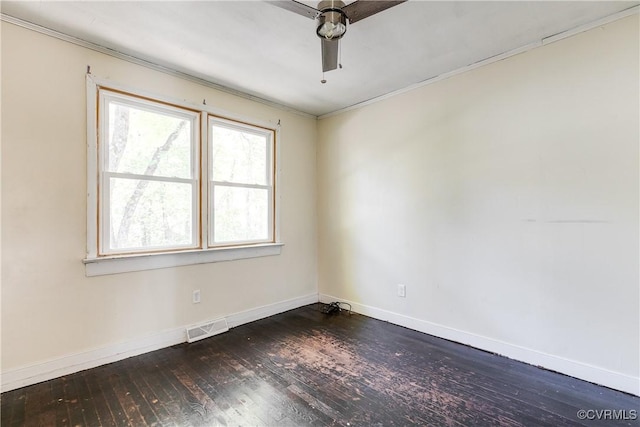 unfurnished room with dark wood-type flooring, visible vents, and baseboards